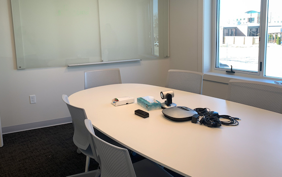 room with conference table, whiteboard and window