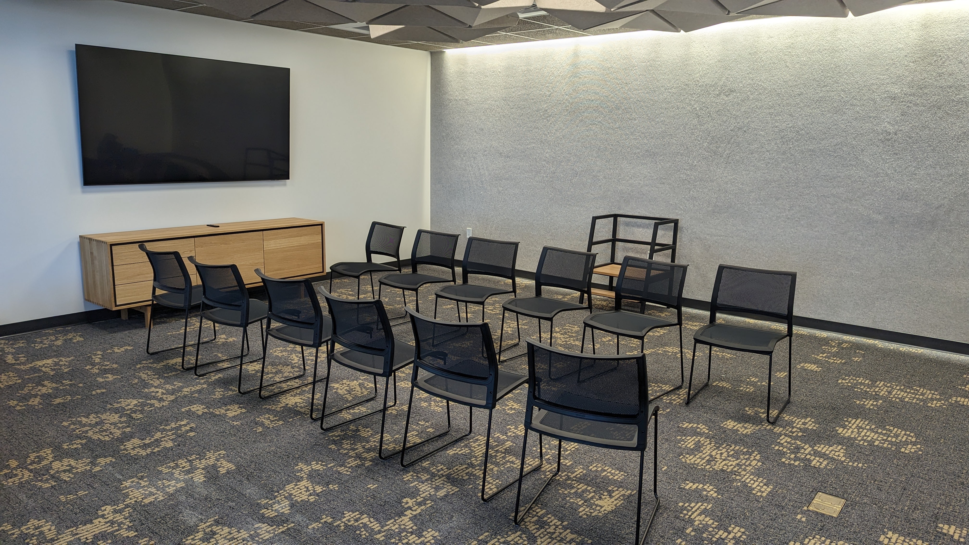 Chairs, TV, and credenza in the conference room.