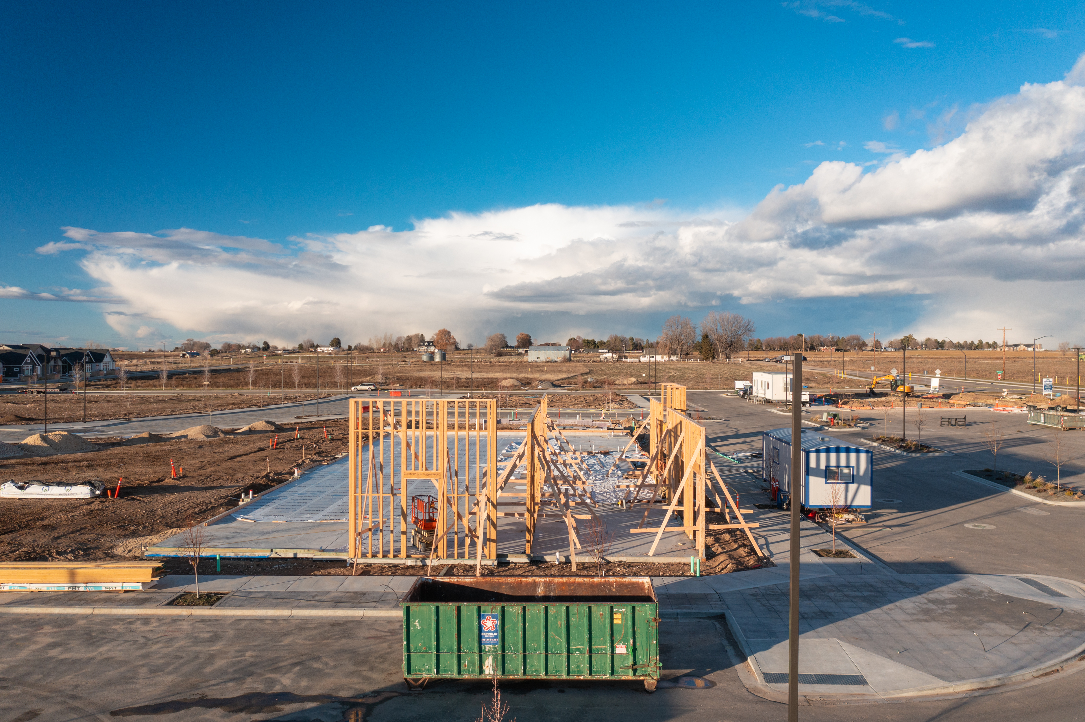 Pinnacle construction site with concrete set and framing starting to go up.