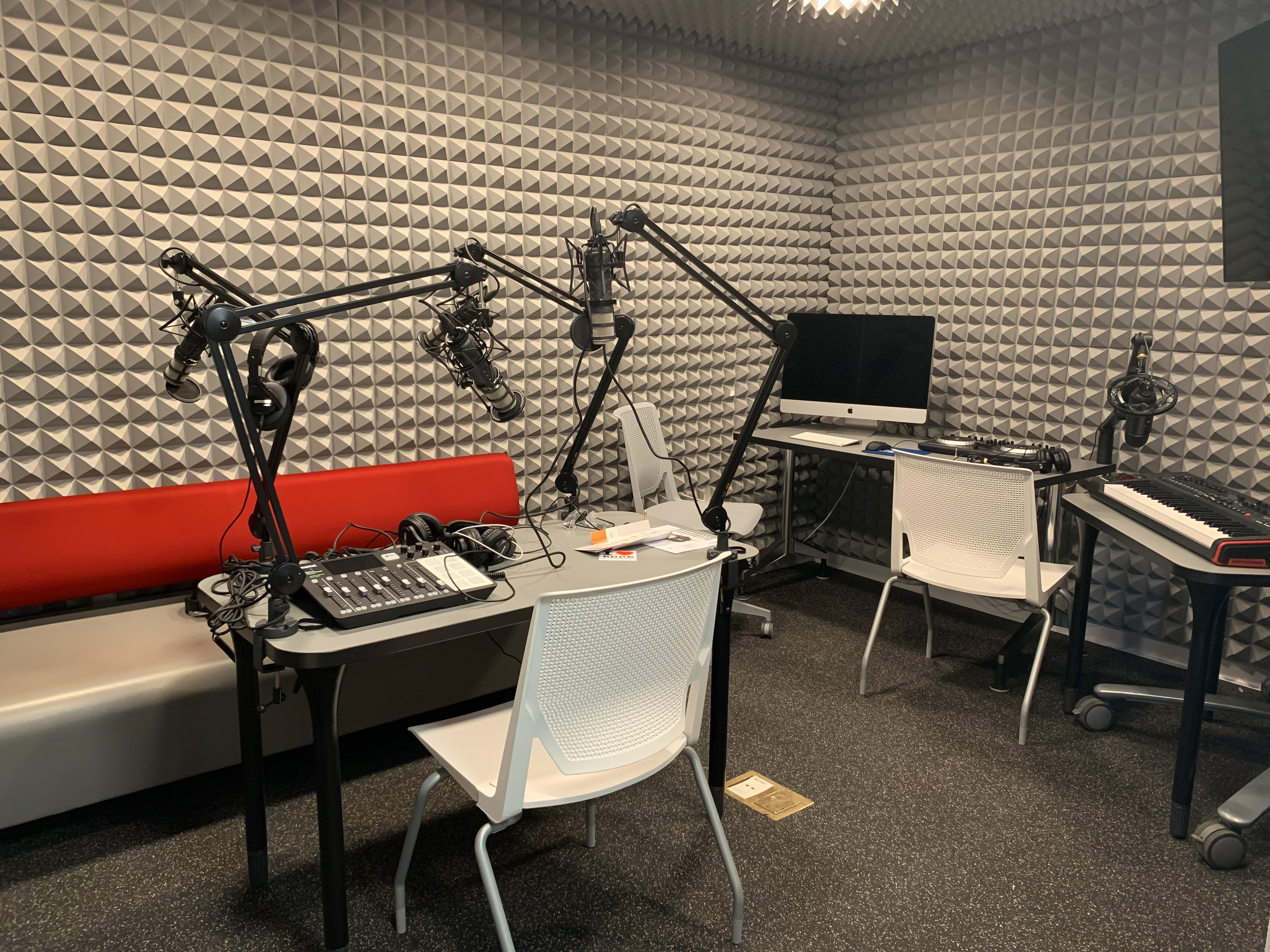 soundproof recording studio with podcast equipment, keyboard, computer