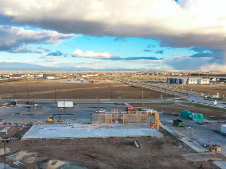 Pinnacle construction site with concrete set and framing starting to go up.