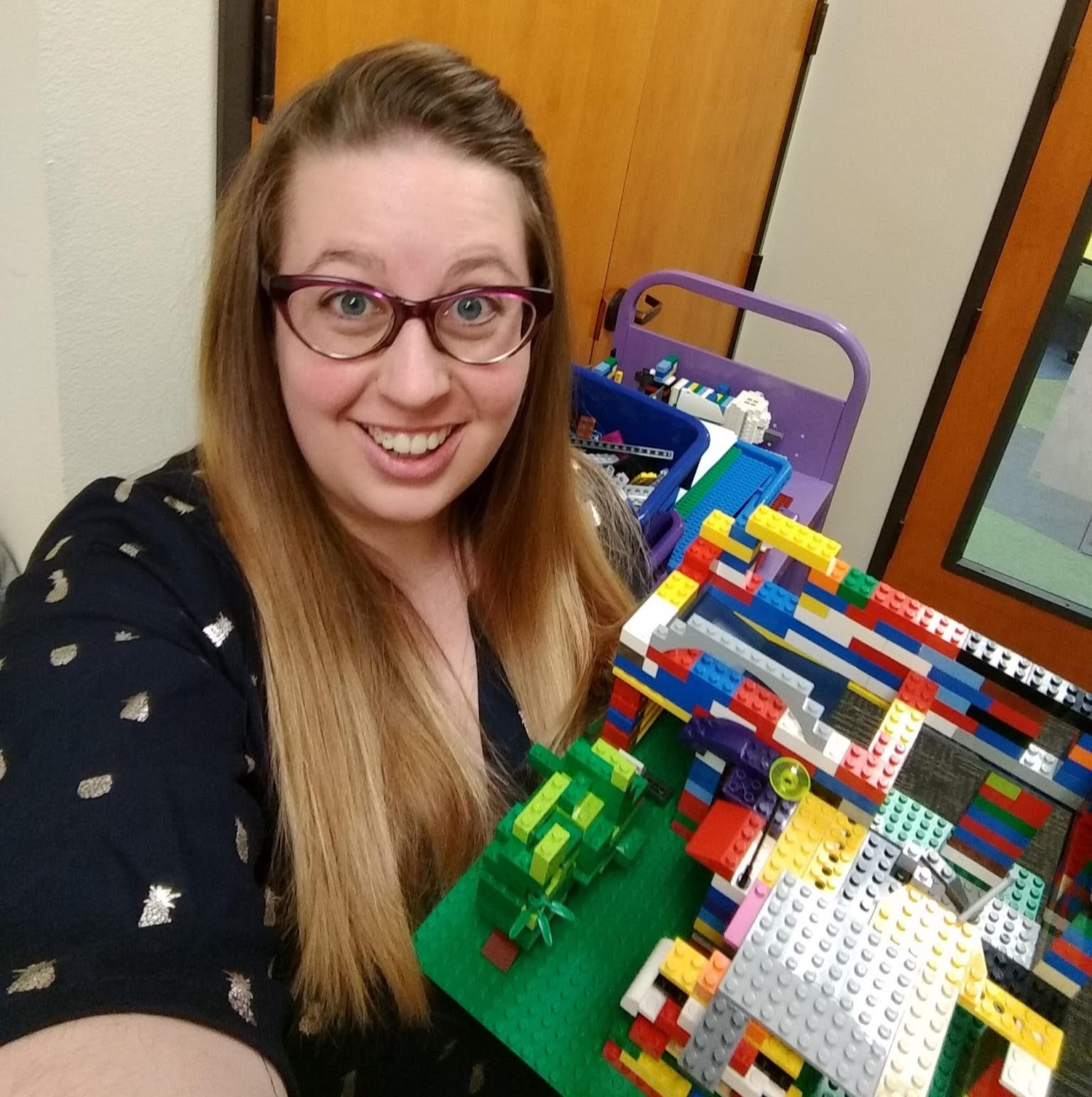 Photo of Korena holding up a Lego construction